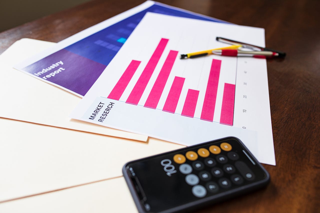 testimonials-img Illustrative market research chart and calculator on wooden desk for business analysis.