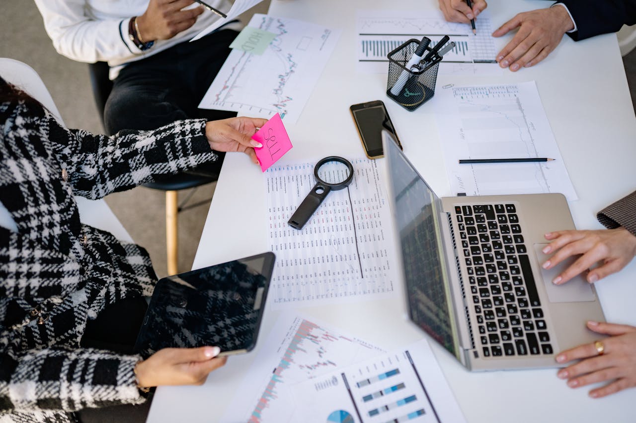 about-01 Business professionals collaborating on financial data analysis in a modern office setting.